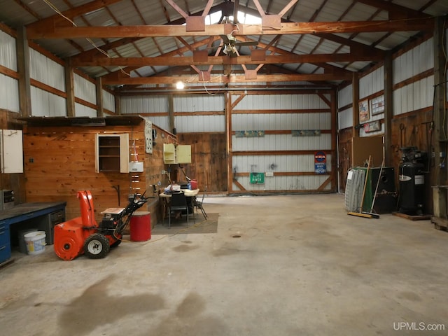 garage with wooden walls and ceiling fan