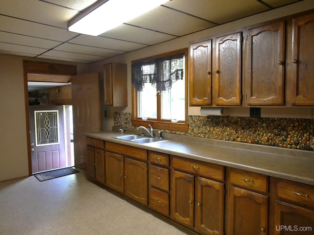 kitchen featuring a paneled ceiling and sink