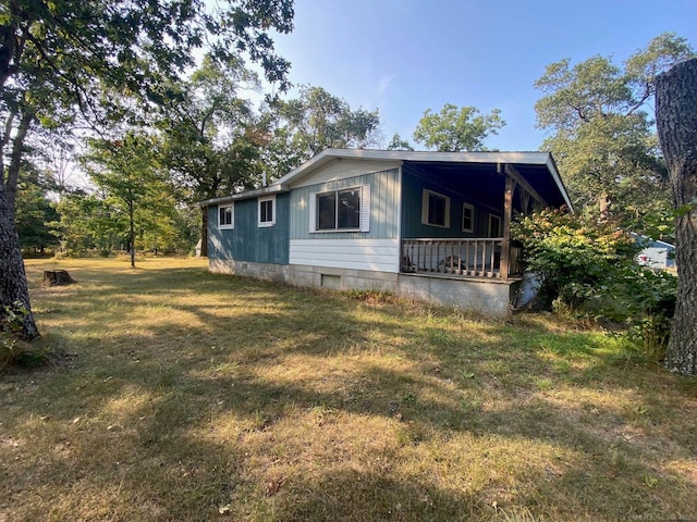 view of side of property with a lawn