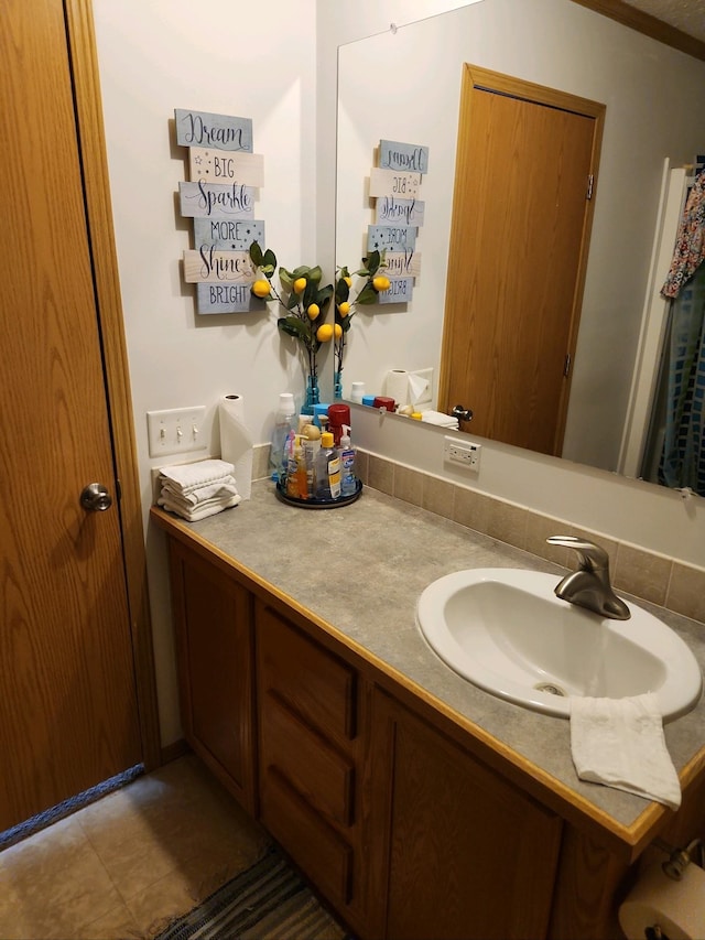 bathroom with tile patterned floors and vanity