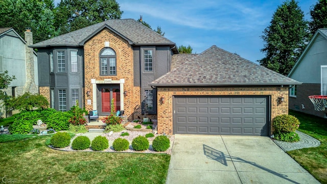 view of front facade with a garage and a front yard