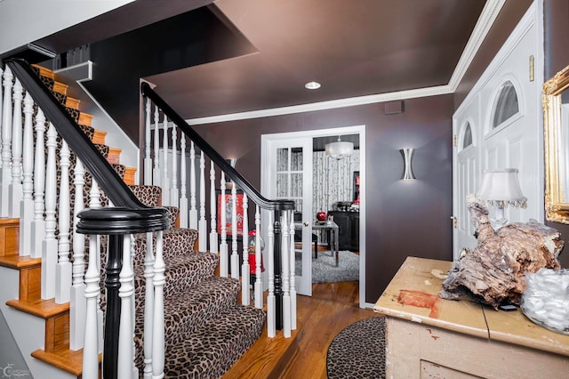 foyer featuring ornamental molding and dark hardwood / wood-style flooring