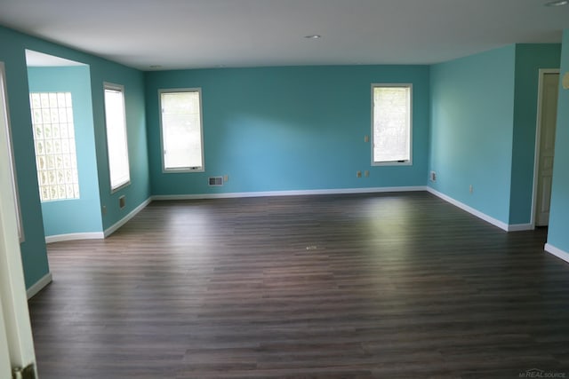 spare room with dark wood-type flooring