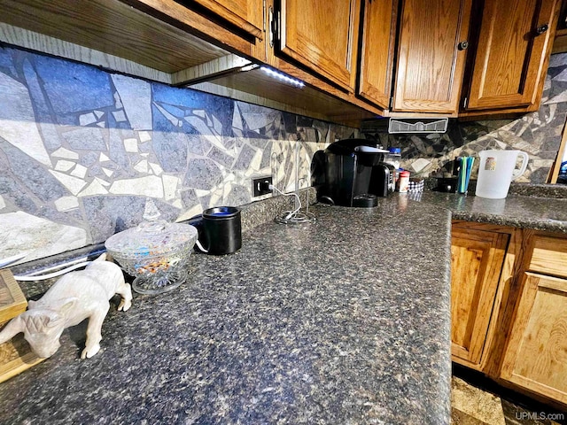 interior details featuring decorative backsplash and a fireplace