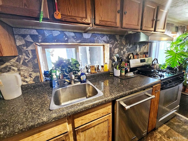 kitchen with appliances with stainless steel finishes, backsplash, and sink