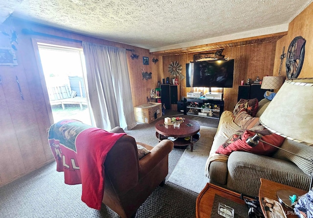 carpeted living room featuring wooden walls and a textured ceiling