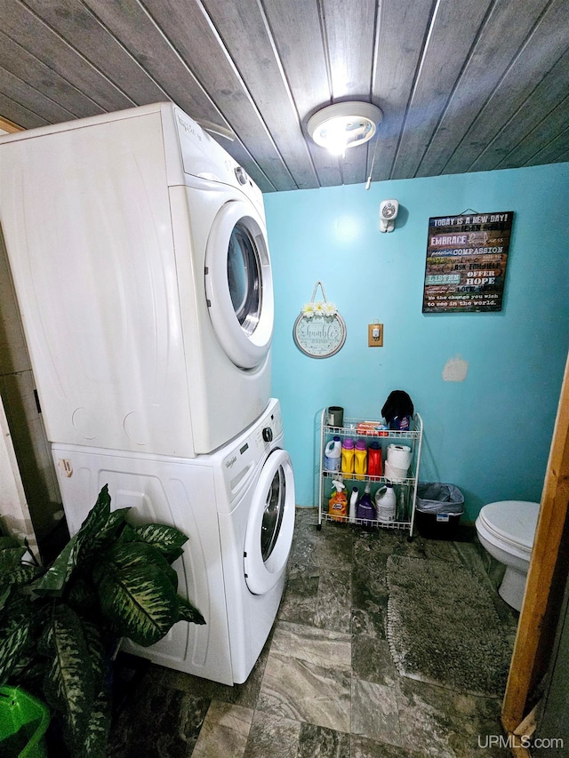 laundry area with wood ceiling and stacked washer and clothes dryer