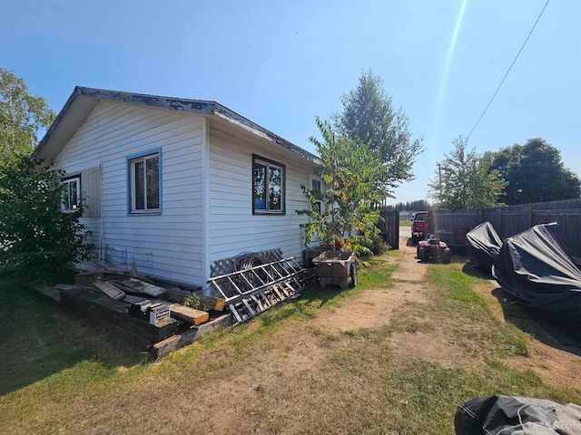 view of home's exterior with a yard