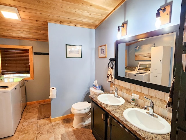 bathroom with decorative backsplash, wooden ceiling, independent washer and dryer, and sink