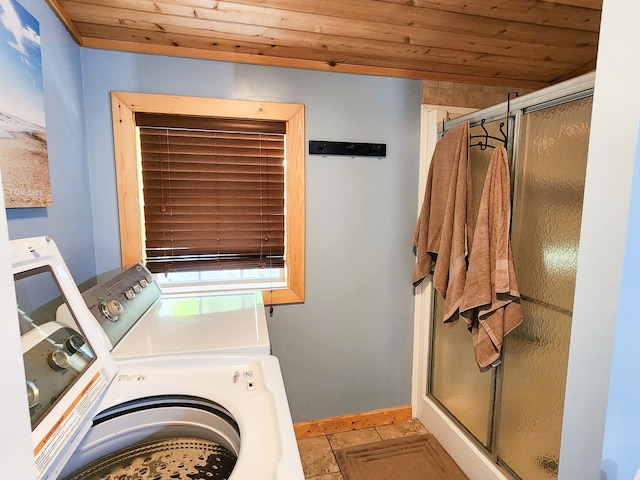 clothes washing area with wood ceiling, light tile patterned floors, and washer and dryer