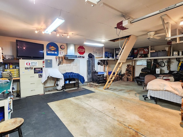 garage with ceiling fan and a garage door opener