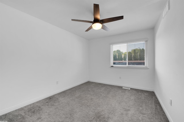 empty room with ceiling fan and carpet floors