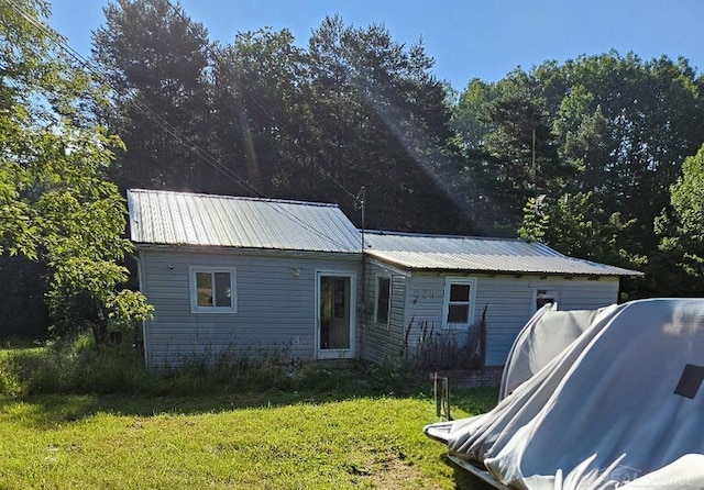 rear view of house with a yard