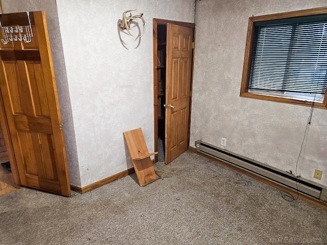 unfurnished bedroom with light colored carpet and a baseboard radiator