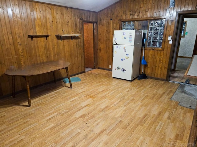 miscellaneous room featuring ornamental molding, wood walls, and light hardwood / wood-style flooring