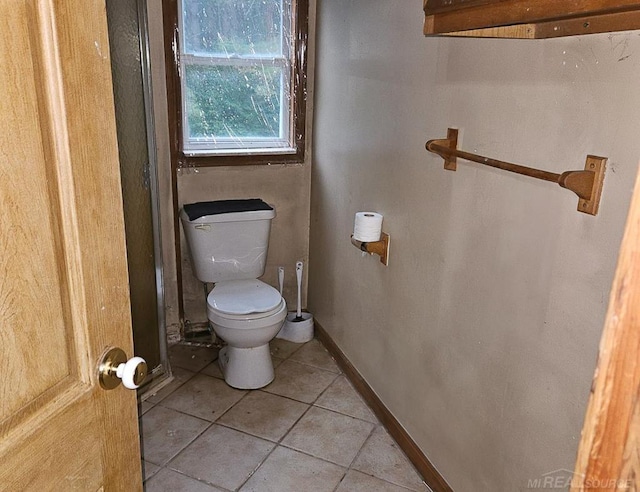 bathroom featuring tile patterned flooring and toilet