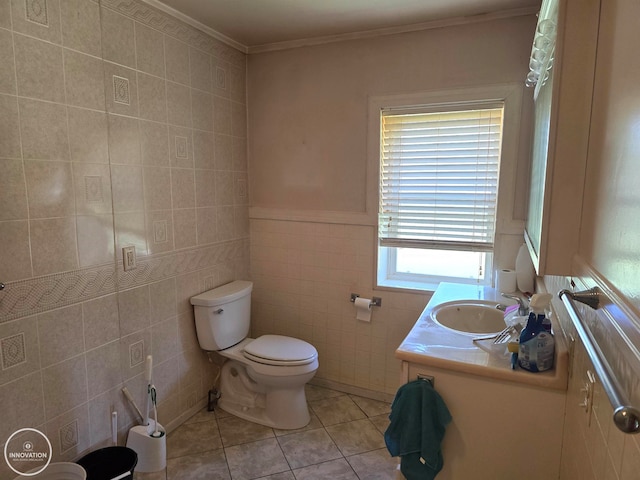 bathroom with vanity, toilet, tile walls, and tile patterned flooring