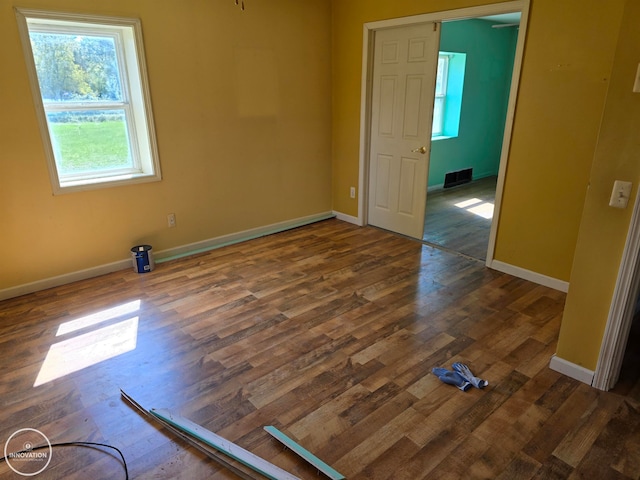 spare room featuring dark hardwood / wood-style flooring