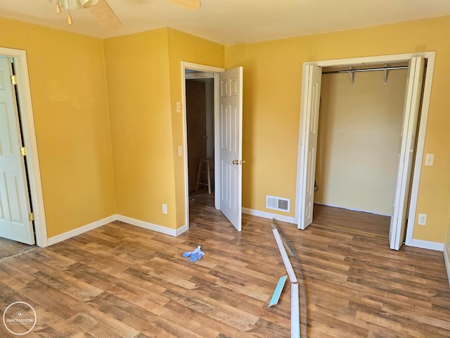 unfurnished bedroom featuring a closet, ceiling fan, and hardwood / wood-style floors