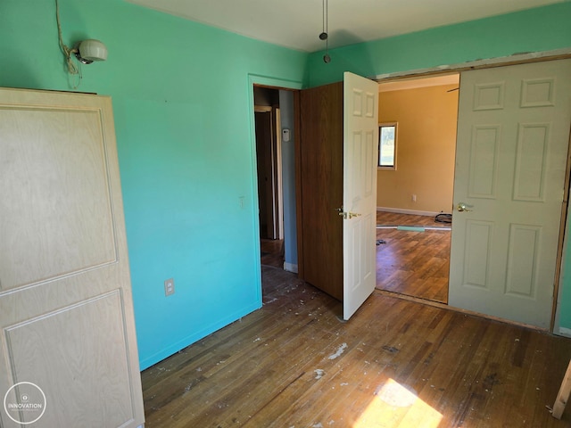 unfurnished bedroom featuring dark hardwood / wood-style flooring