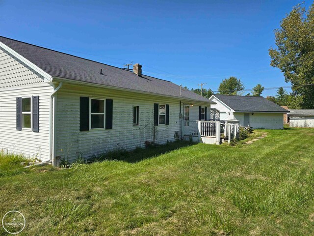 rear view of house with a lawn