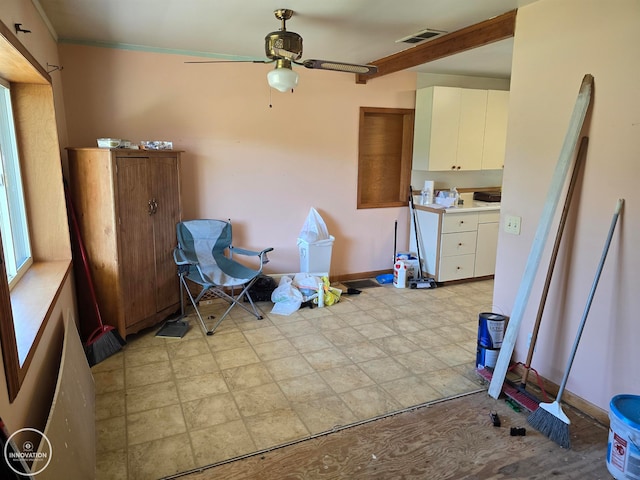 kitchen with white cabinets and ceiling fan