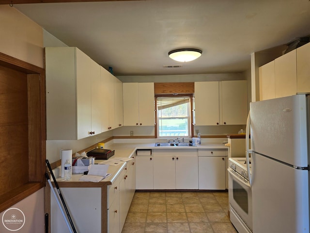 kitchen featuring white cabinets, sink, and white appliances