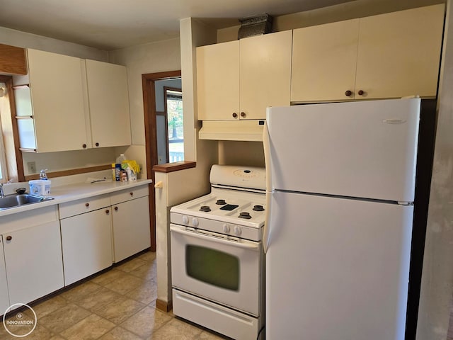 kitchen featuring white cabinetry, sink, and white appliances