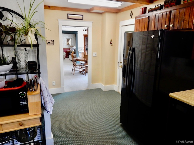 kitchen with carpet flooring and black appliances