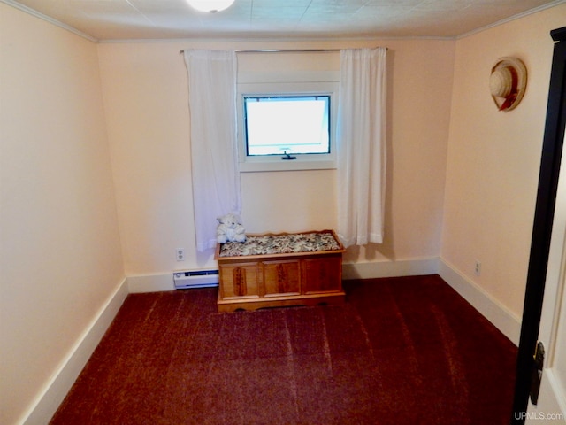 carpeted spare room featuring ornamental molding and baseboard heating