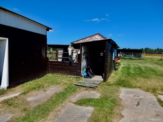 view of outbuilding featuring a lawn