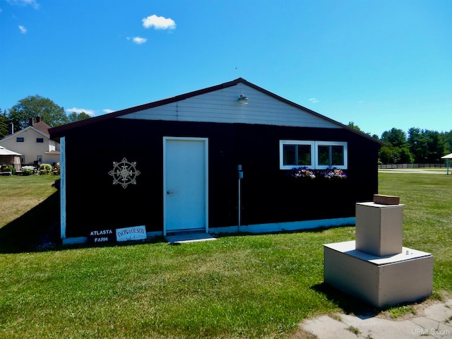 view of outbuilding featuring a lawn