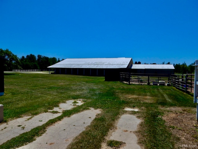 view of yard with an outdoor structure and a rural view