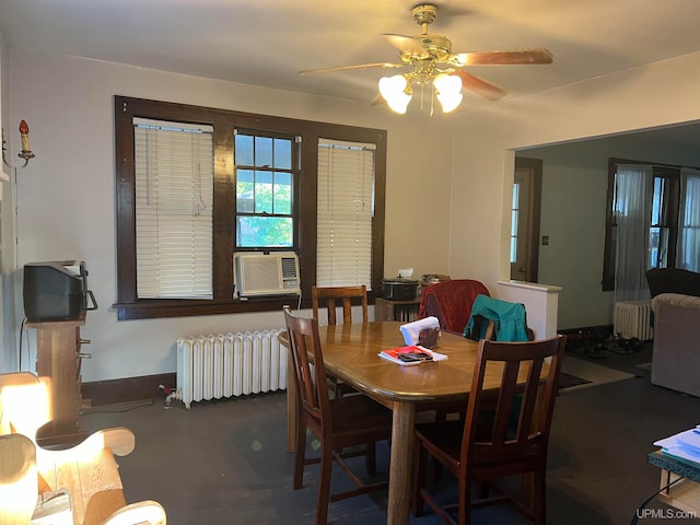 dining room featuring radiator heating unit, cooling unit, ceiling fan, and concrete floors