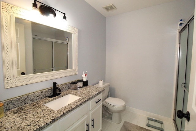 bathroom with tile patterned floors, a shower with shower door, vanity, and toilet