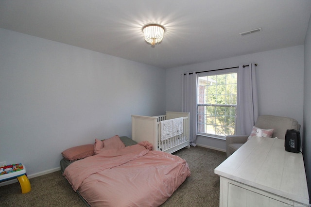 bedroom featuring dark carpet