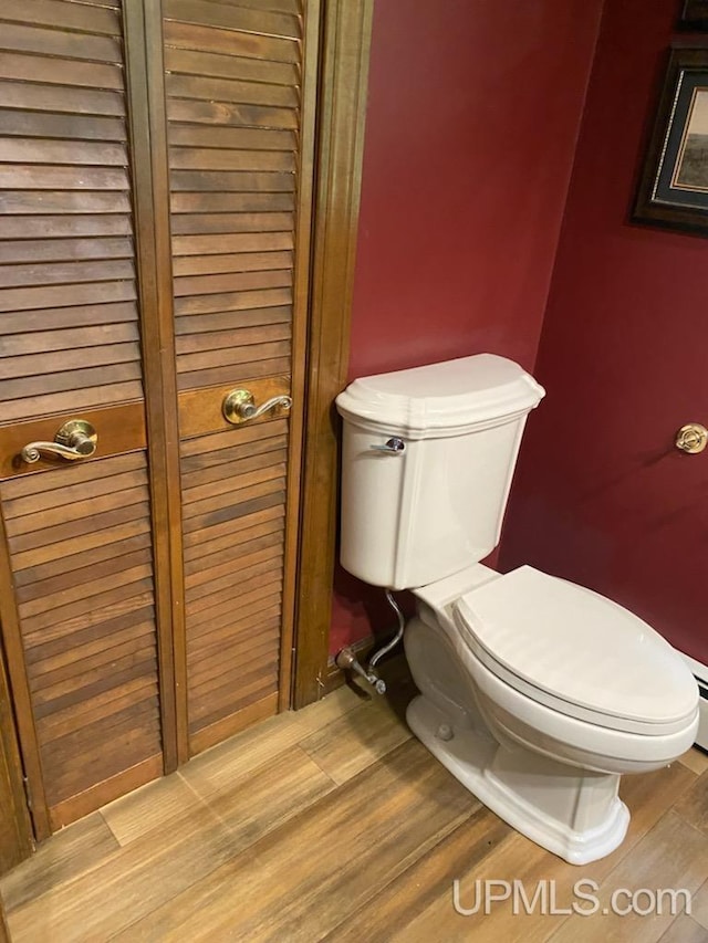 bathroom featuring toilet and hardwood / wood-style flooring