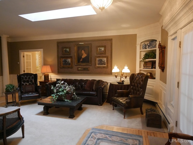 living room featuring carpet, a baseboard heating unit, crown molding, a skylight, and built in features