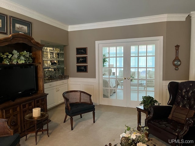 living area featuring light colored carpet, ornamental molding, sink, and french doors