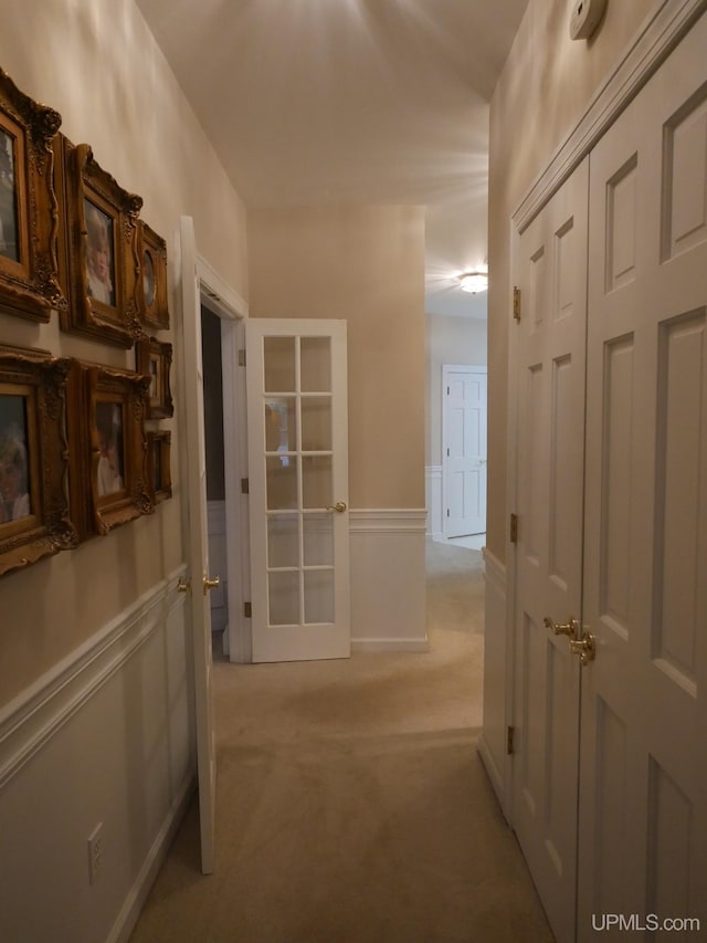 hall with light colored carpet