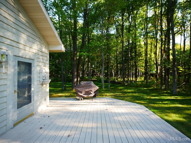 wooden terrace featuring a lawn