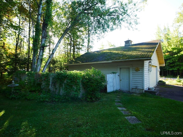 view of outdoor structure featuring a yard and a garage