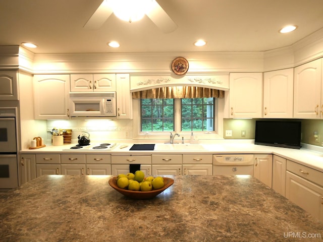 kitchen with white cabinets, white appliances, ceiling fan, and sink