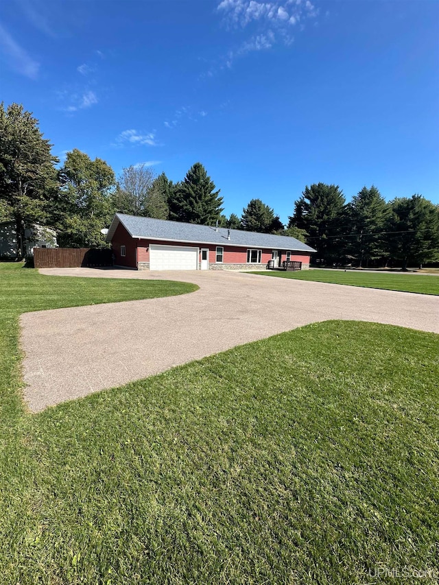 view of front of house with a garage and a front lawn