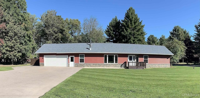 ranch-style house featuring a garage and a front yard