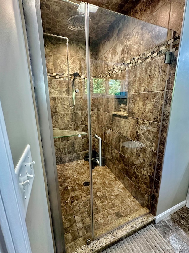 bathroom featuring a shower with door