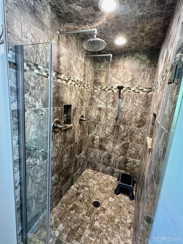 bathroom with a shower with door