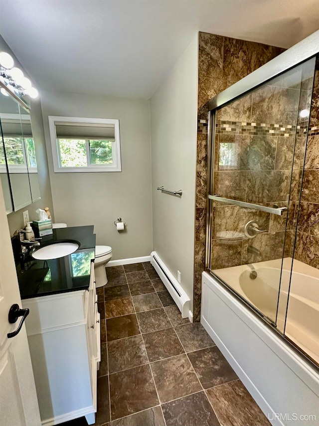 full bathroom with vanity, baseboard heating, enclosed tub / shower combo, and toilet