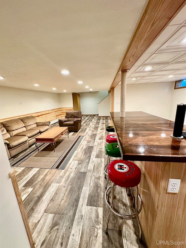 bar featuring hardwood / wood-style flooring