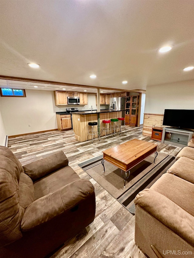 living room featuring light wood-type flooring and indoor bar